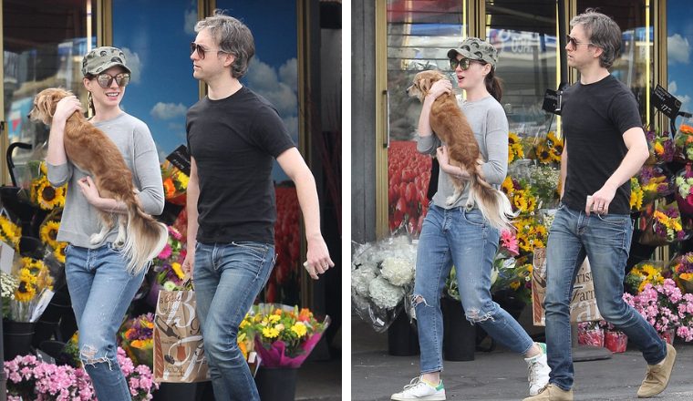 Puppy love! Anne Hathaway cradles her precious dog while out with hubby ...